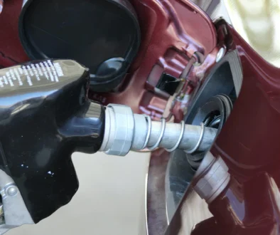 a close up of a person holding a gas pump