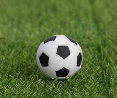 Football soccer ball on grass field