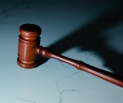 a wooden judge's hammer sitting on top of a table