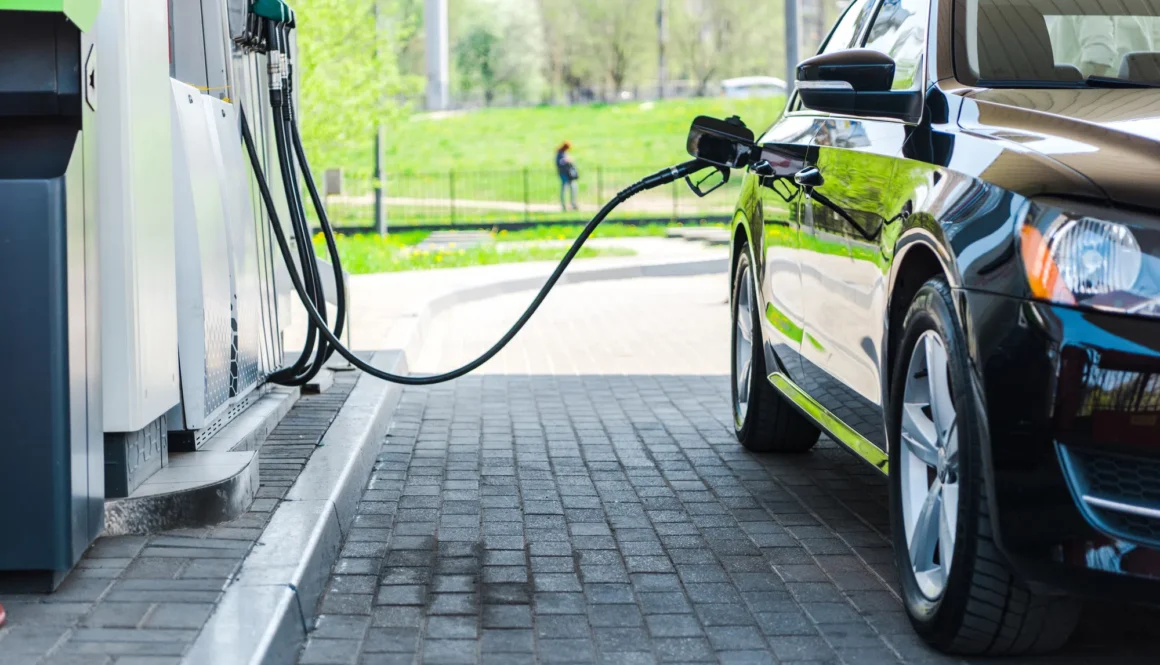 black modern car refueling with benzine on gas station