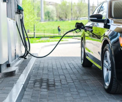 black modern car refueling with benzine on gas station