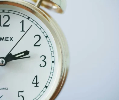 round Timex analog clock at 2:33