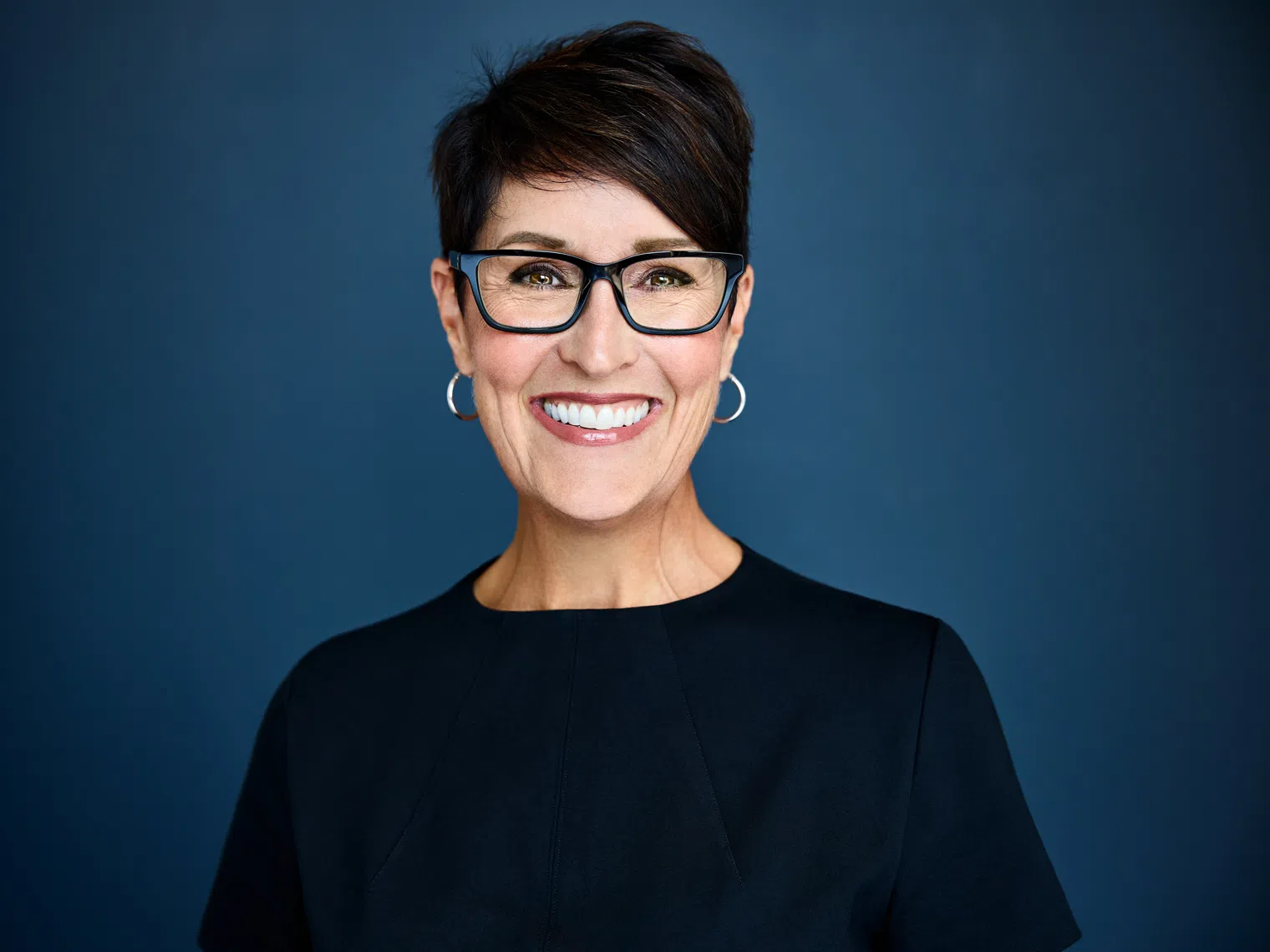 Woman with black short hair smiling at the camera 