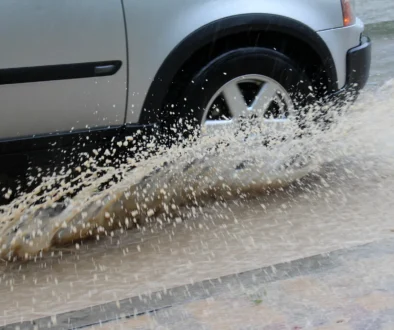 Car wheels in water during heavy rain