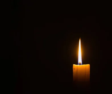 horizontal photo of candle on black background with copyspace