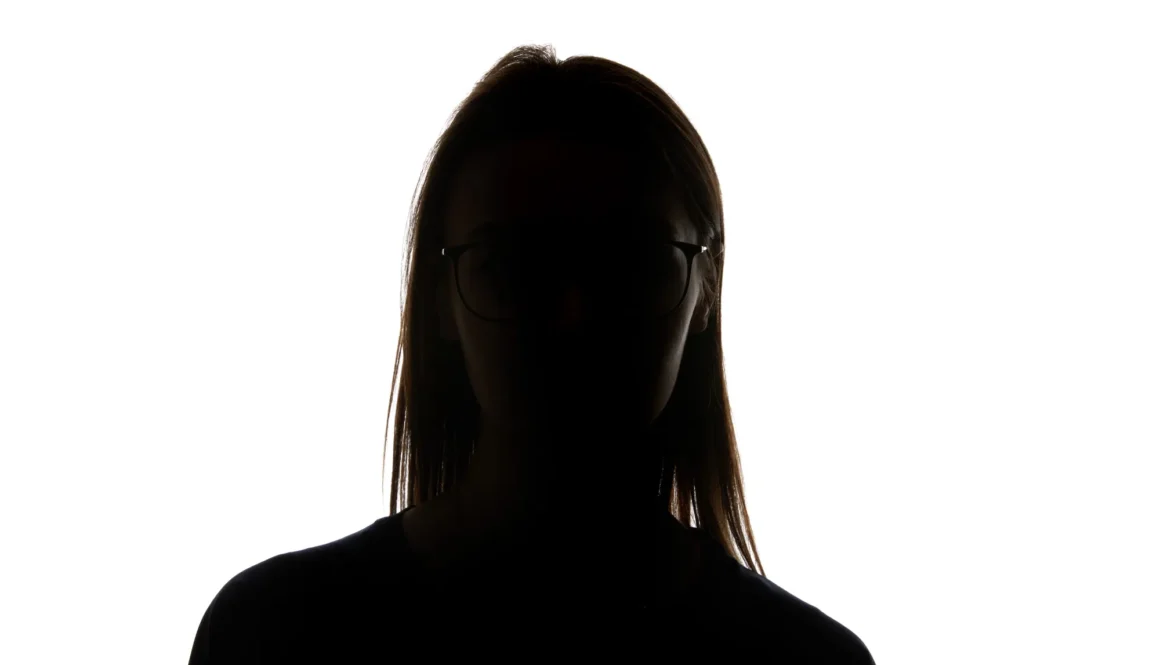 Silhouette of woman in glasses looking at camera isolated on white