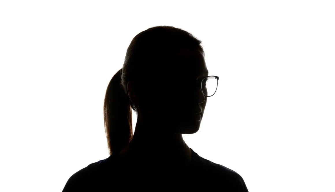 Silhouette of woman in glasses looking away isolated on white