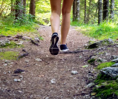 Woman trail, hiking, wandering, walking concept in forest in summer