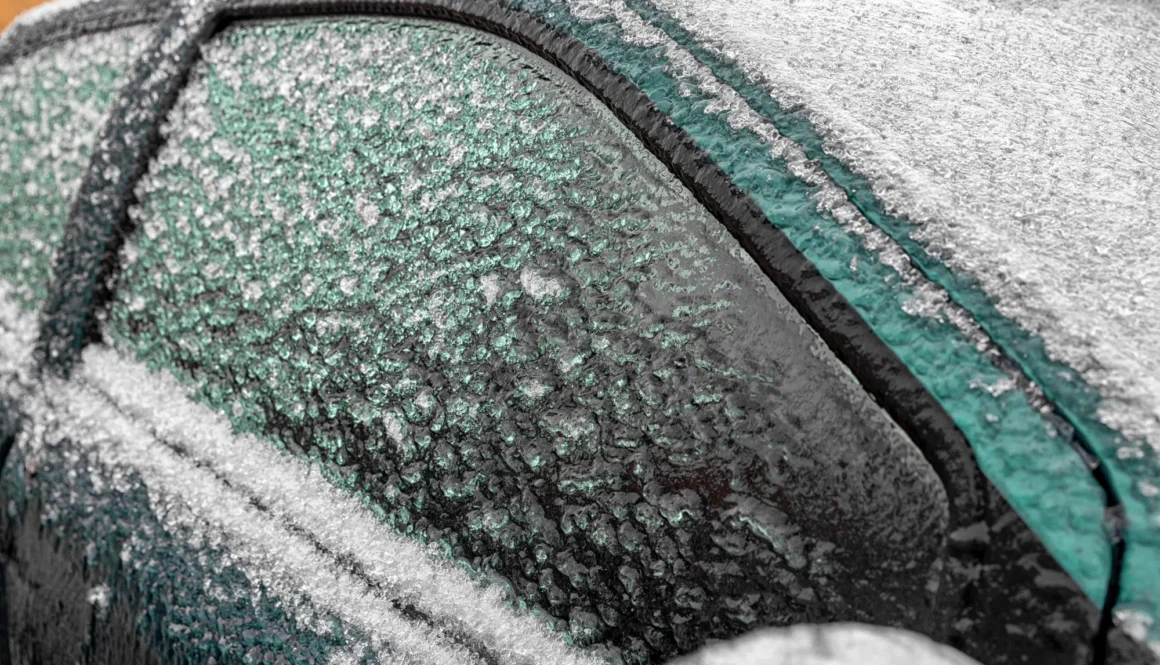 Car covered by icicles from freezing rain in winter.