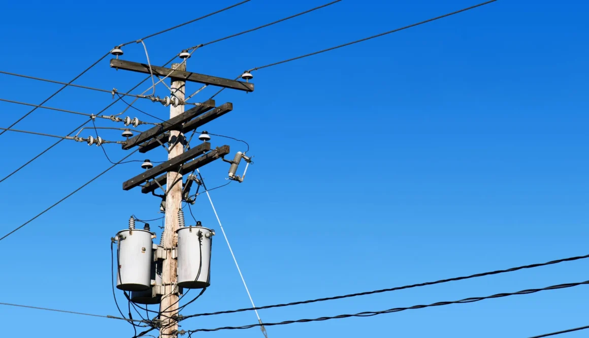 Power line post and blue sky