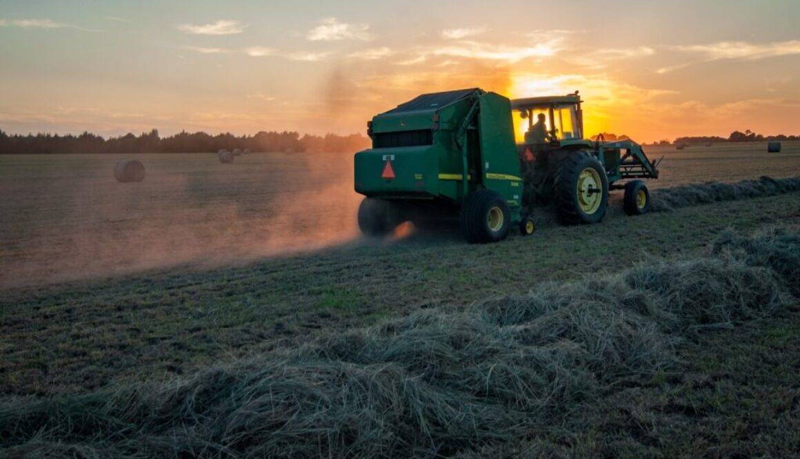 green farm heavy equipment on green field