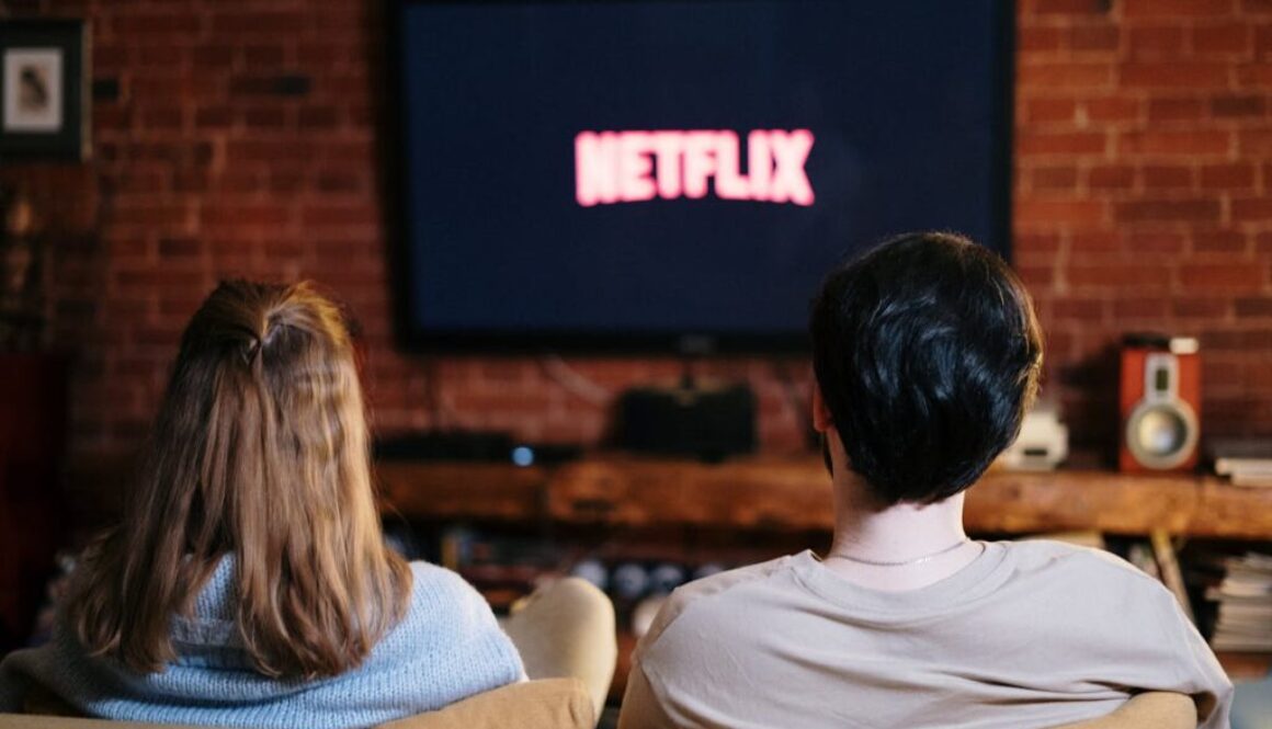 A couple enjoys a relaxed evening watching Netflix in their living room.