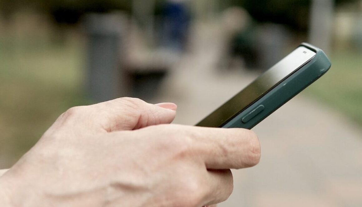 A person holding a cell phone in their hand