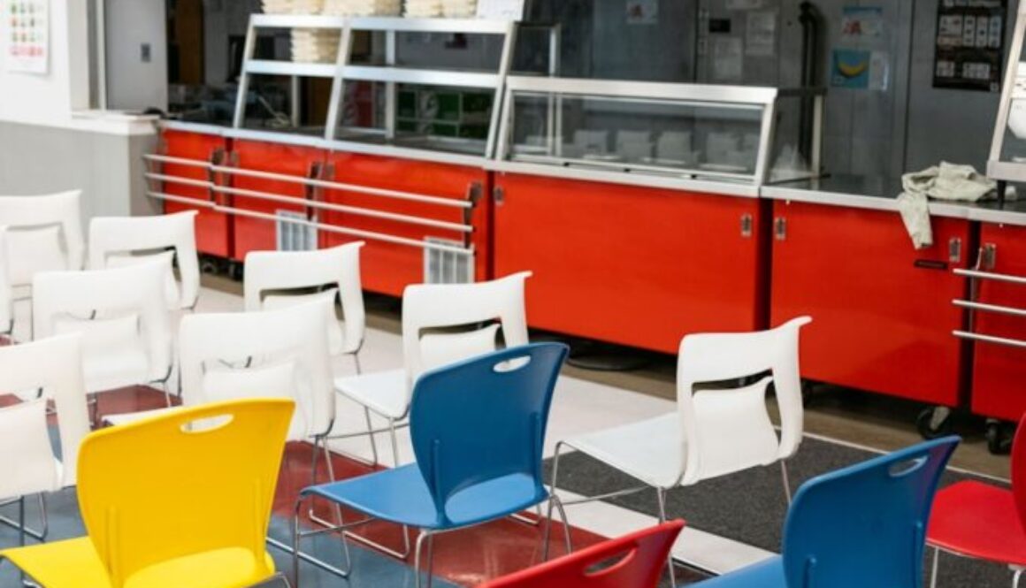 a cafeteria filled with lots of colorful chairs