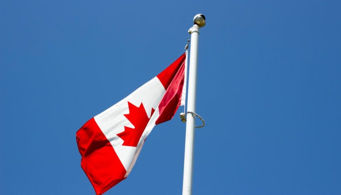 flag of Canada under blue sky at daytime
