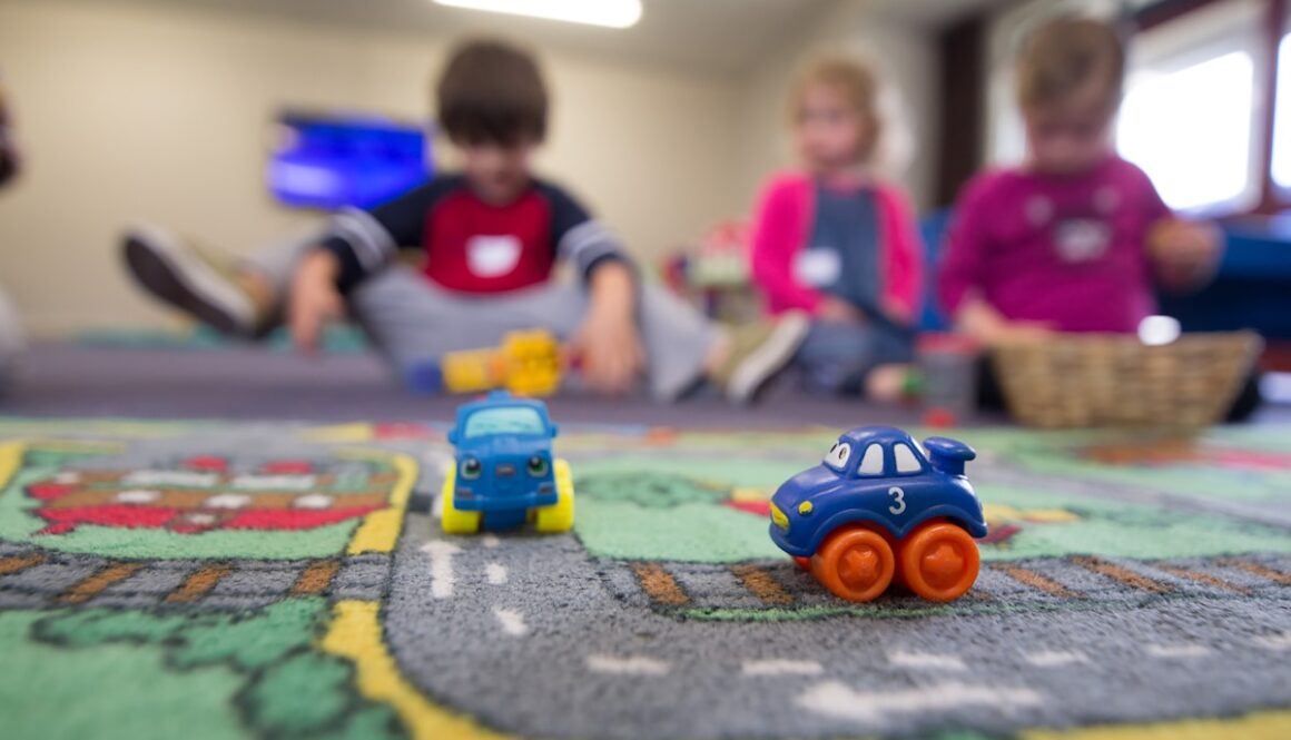 a group of children playing with toys on the floor