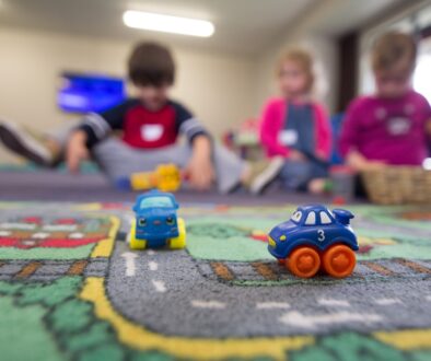 a group of children playing with toys on the floor