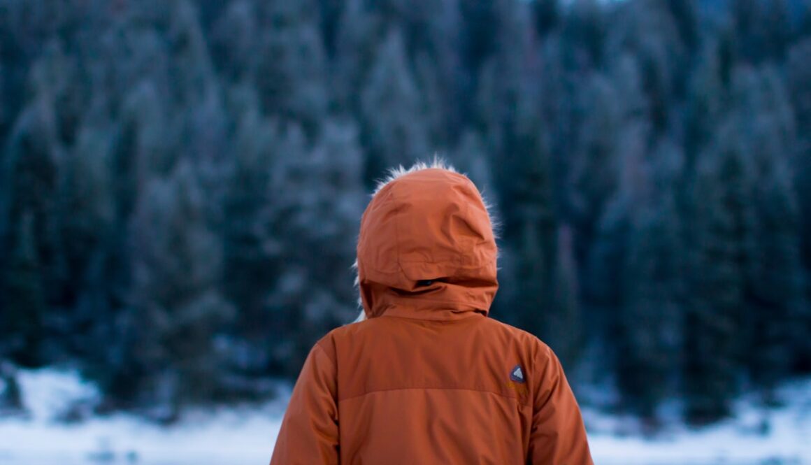 shallow focus photography of person facing trees