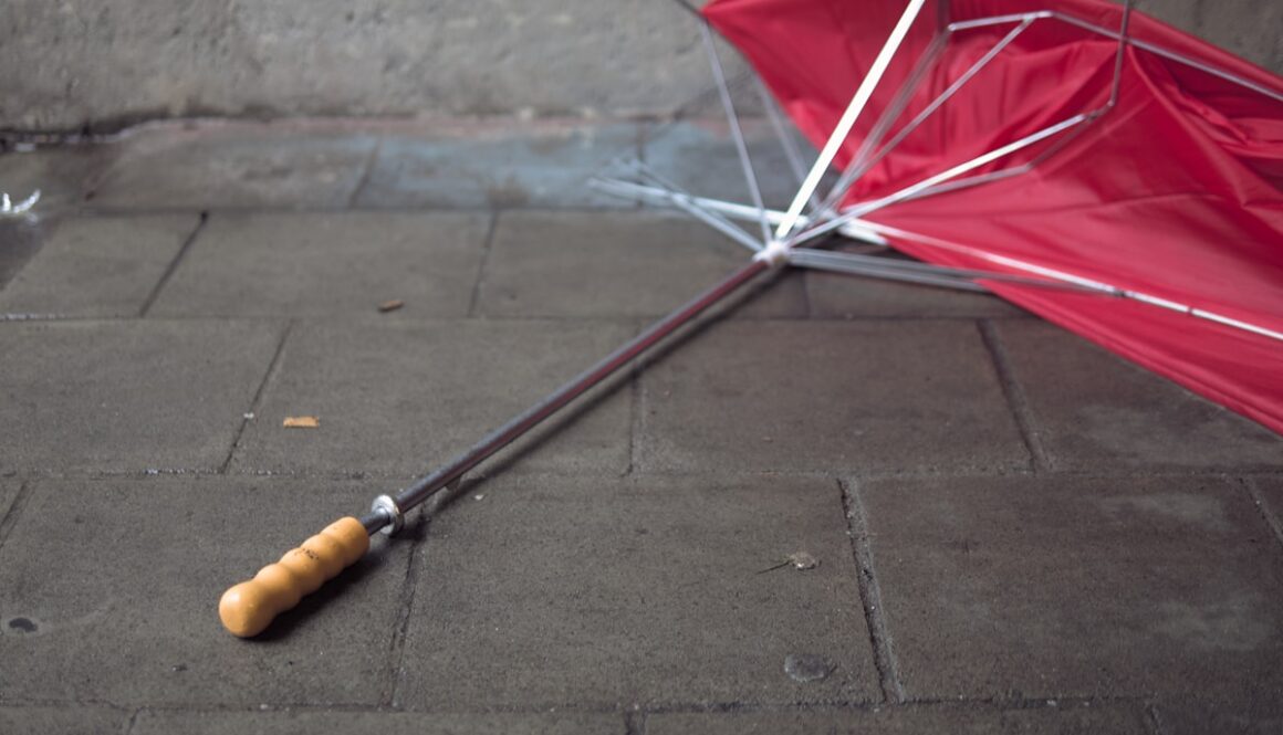 a red umbrella laying upside down on the ground