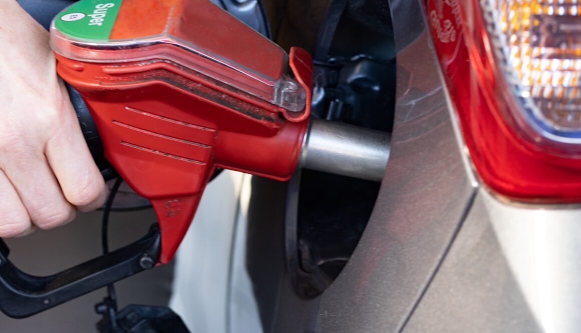 a person pumping gas into a car at a gas station