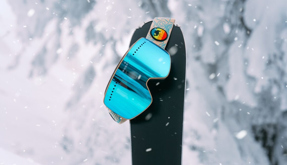 blue and black surfboard on snow covered ground