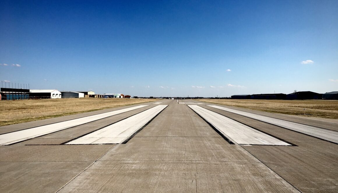 gray asphalt road under blue sky during daytime