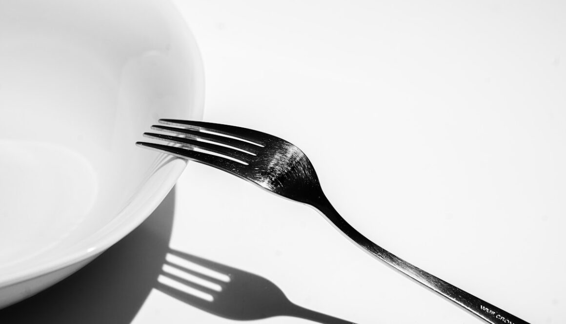 silver fork on white ceramic plate