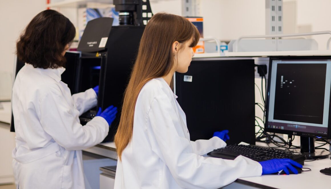 Two scientists working on computers in a laboratory.