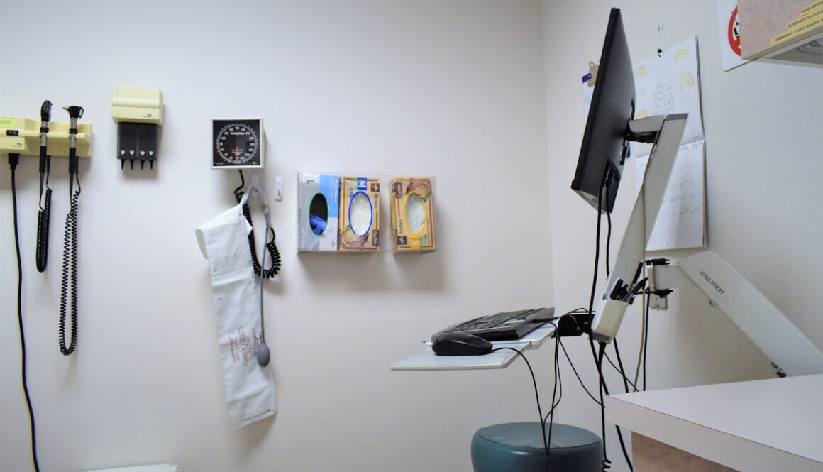 a room with a desk, phone, and other items on the wall