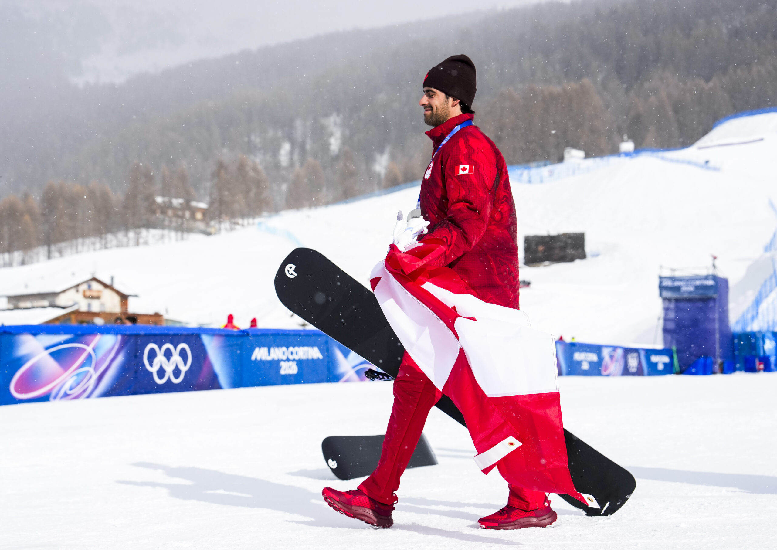 Team Canada’s Éliot Grondin celebrates winning a silver medal in the mens snowboard cross at the Milano Cortina 2026 Olympic Winter Games in Italy on Thursday, February 12, 2026. Photo by Mark Blinch/COC