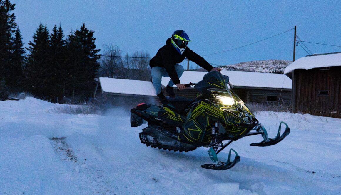 A person riding a snowmobile in the snow