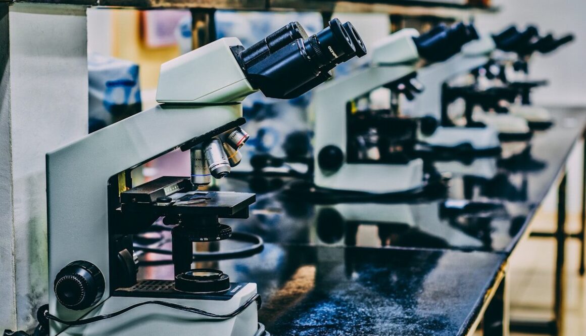 white microscope on top of black table