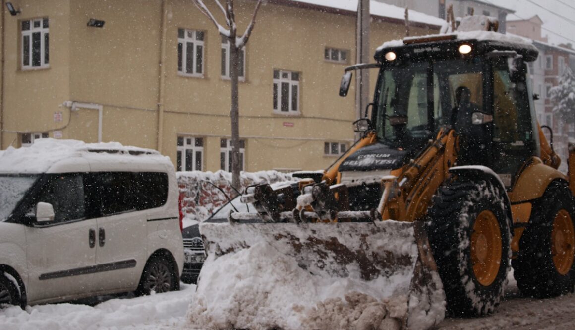 a snow plow is parked on the side of the road