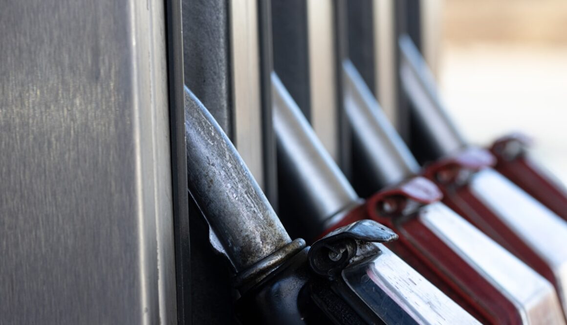 a row of knives hanging on the side of a building