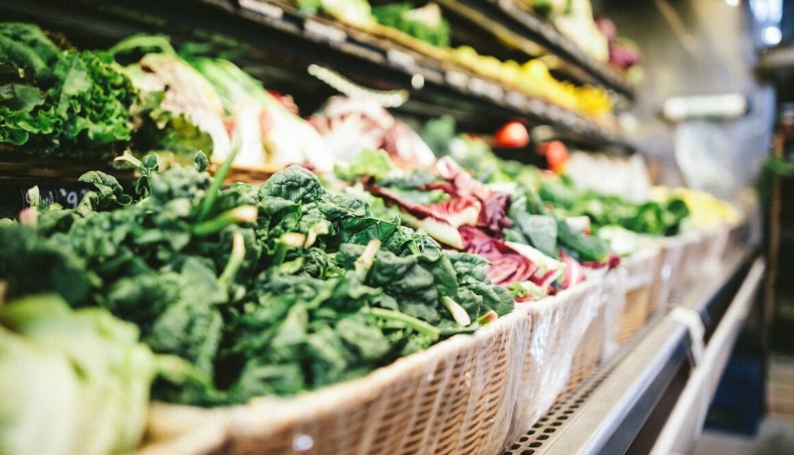 row of vegetables placed on multilayered display fridge