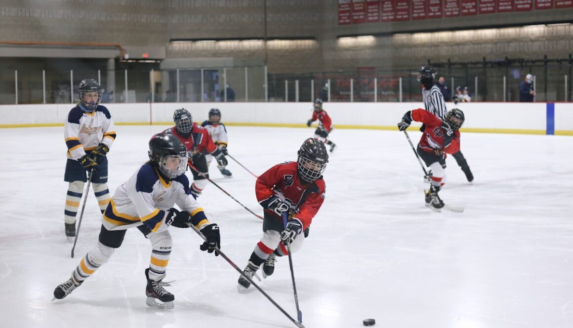 men playing ice hockey on ice stadium