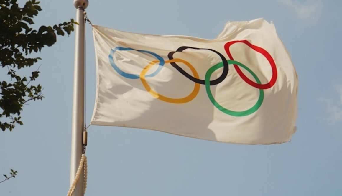 A white flag with the olympic rings on it