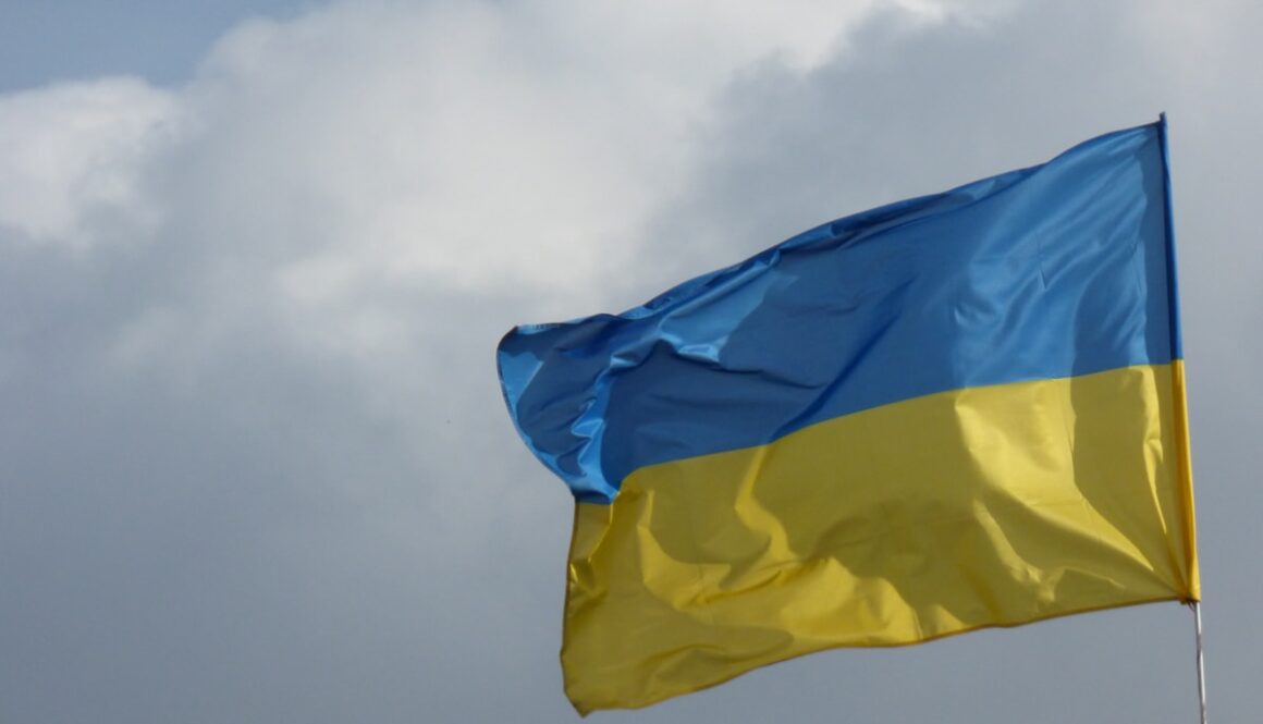 a blue and yellow flag flying in the sky