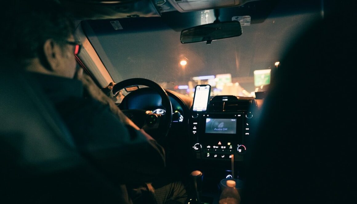a man driving a car at night in the dark