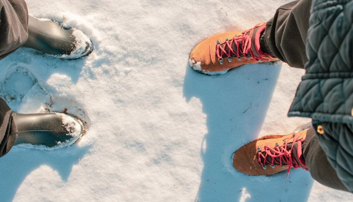 Two pairs of boots standing in the snow