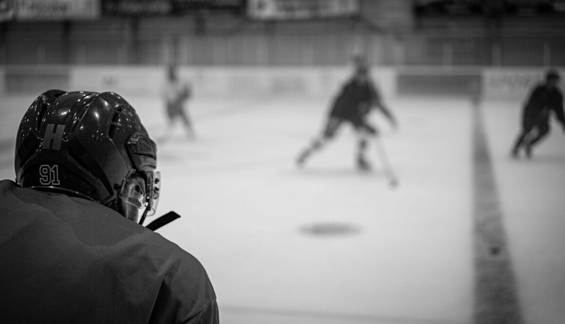 a group of people playing a game of ice hockey