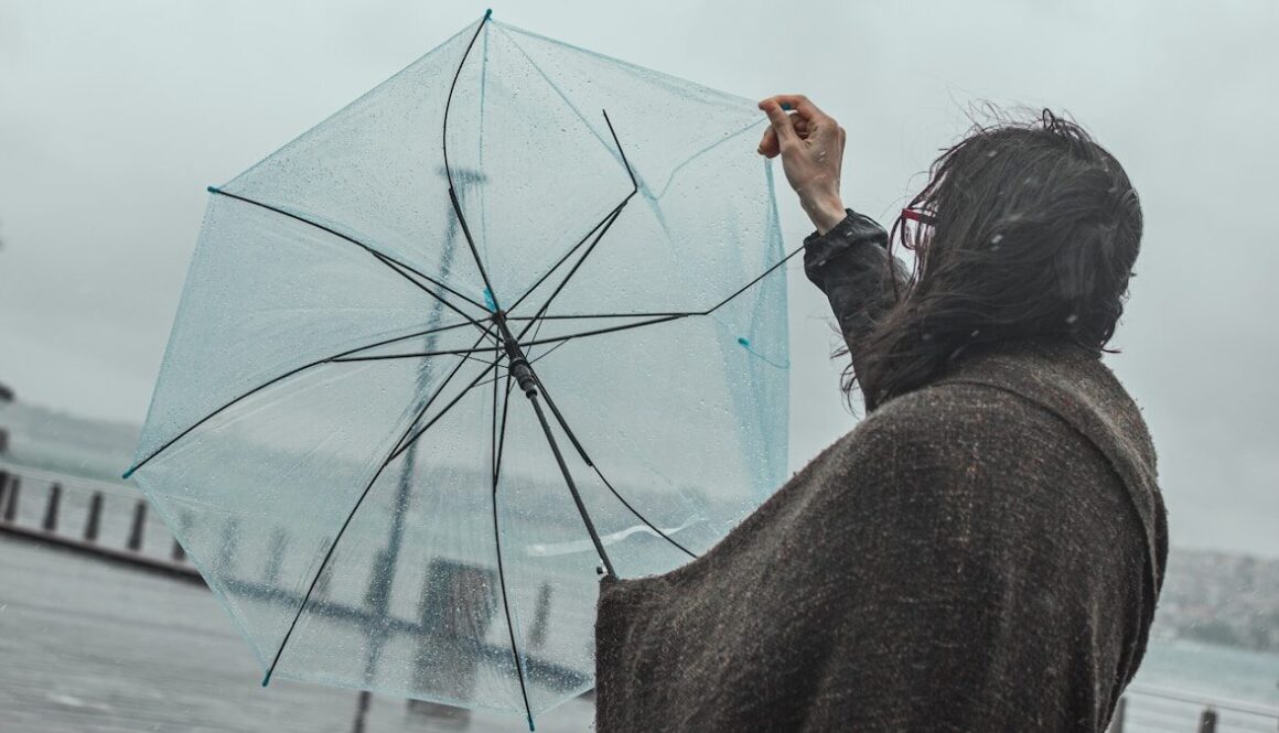 woman in black jacket holding umbrella