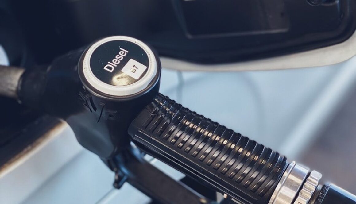 a close up of a gas pump with a car in the background