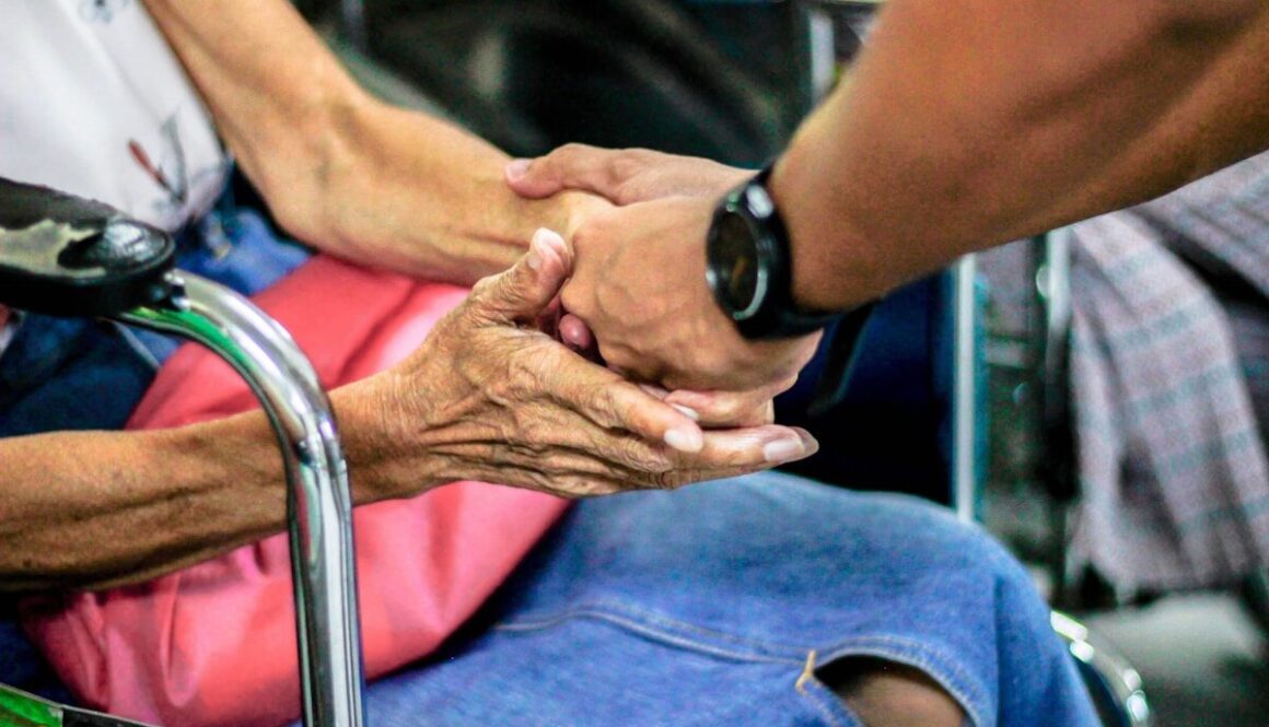 man holding hand with woman on chair