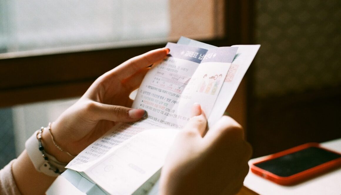 person holding white printer paper