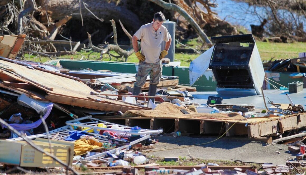 a man standing on top of a pile of junk