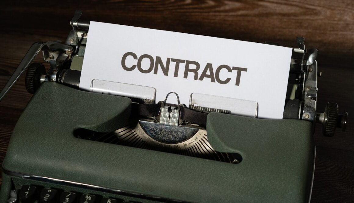 a close up of a typewriter with a sign that reads contact