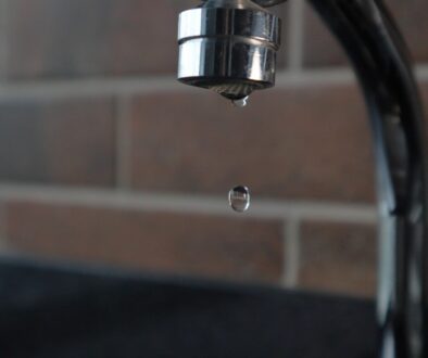 a faucet with a water drop hanging from it