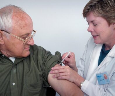 woman injecting syringe on mans arm