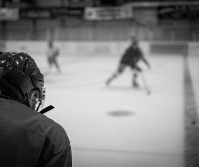 a group of people playing a game of ice hockey